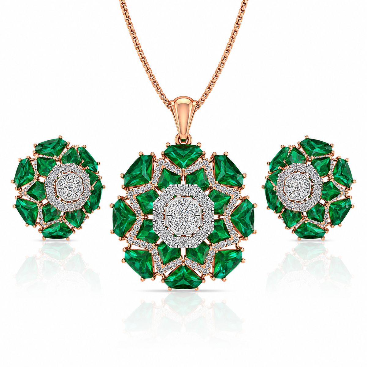 Jewelry set with emerald green gemstones and rose gold accents on a white background