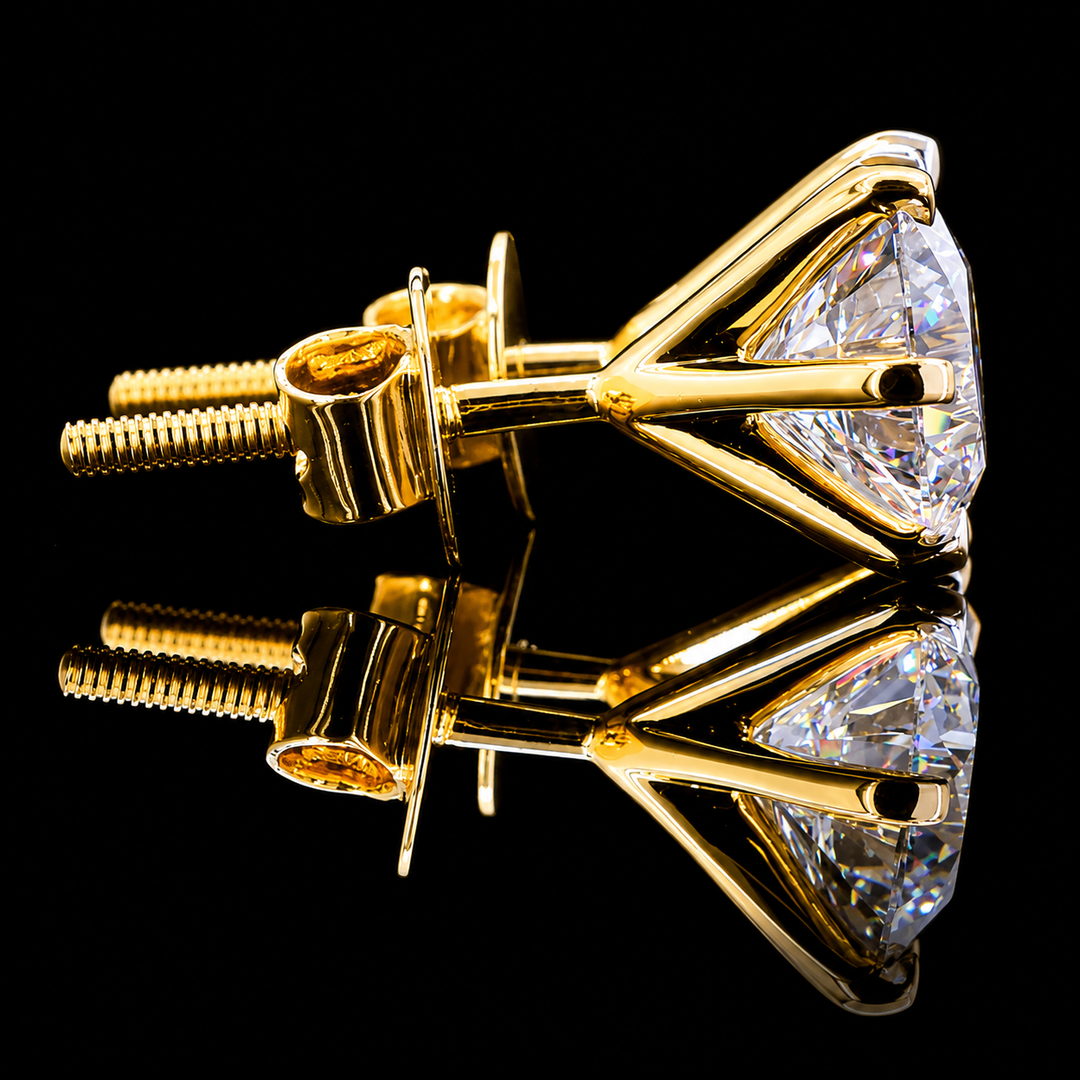 A pair of yellow gold diamond stud earrings with large clear round-cut stones, shown on a reflective black background.