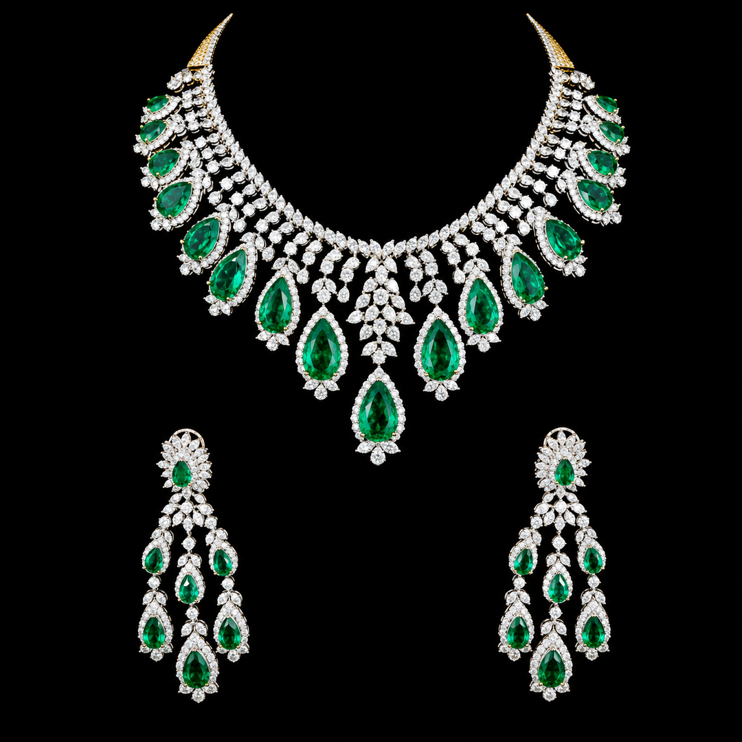 A gold and silver jewelry set featuring a statement necklace and matching drop earrings, embellished with large emerald-cut green gemstones and numerous clear stones, displayed against a solid black background.