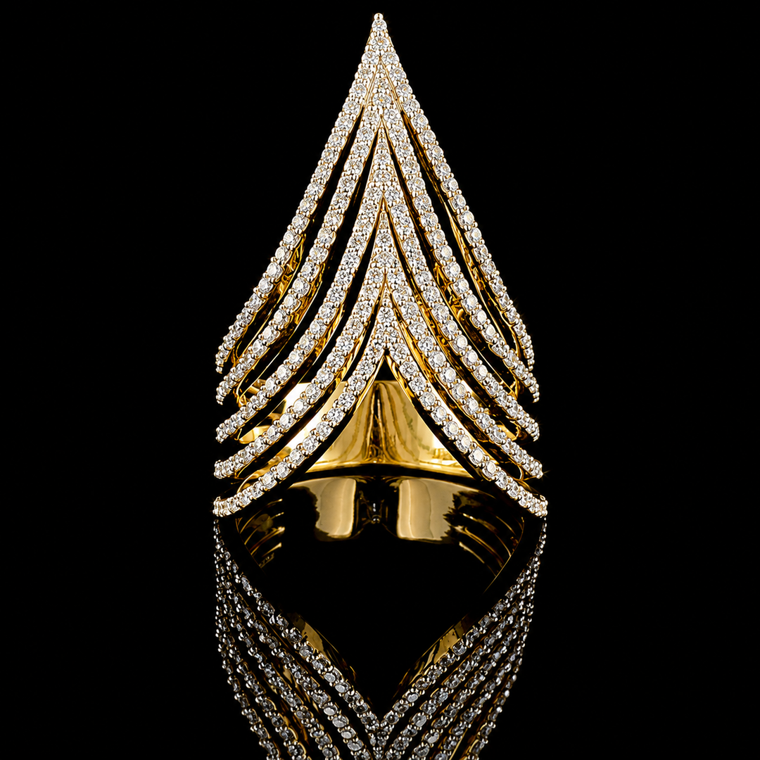 A gold ring with multiple pointed, chevron-like rows of clear stones, photographed on a black reflective surface against a black background.