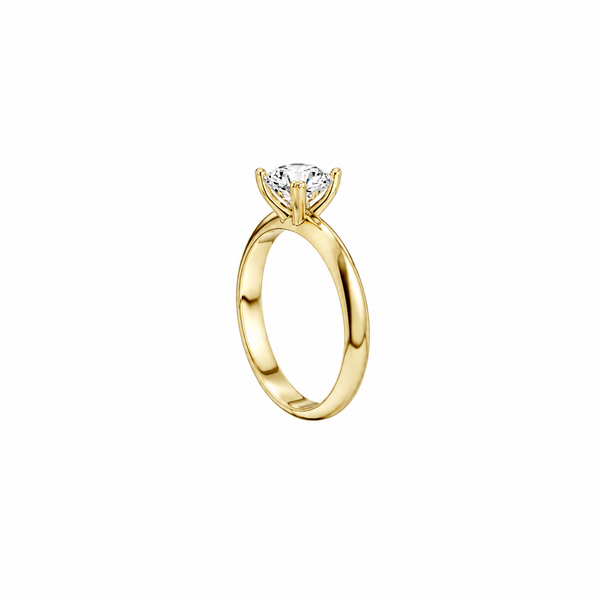 Gold ring with a diamond on a white background